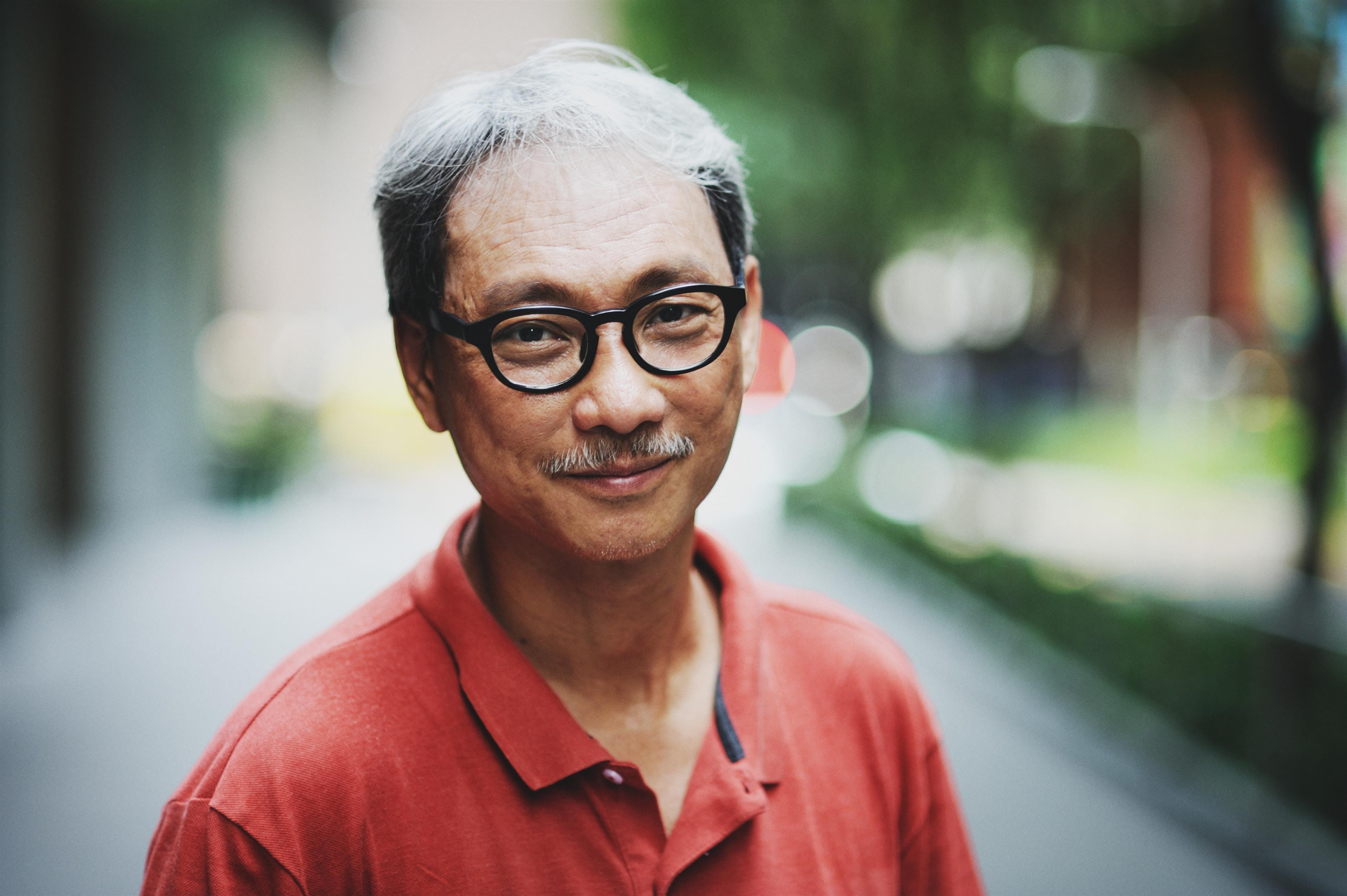 Asian man with glasses in the park